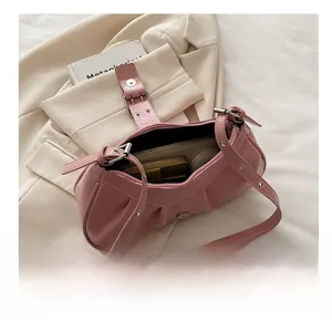 Pink pleated leather shoulder bag showing inner space for wallet and compact mirror