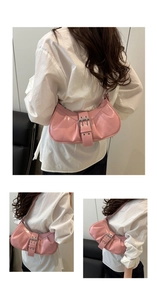 Pink crescent shoulder bag with pleated faux leather and buckle detail shown from three angles