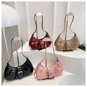 Detail of four colorful pleated crescent shoulder bags with sleek metallic buckles