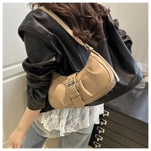 Detail of khaki hobo bag featuring pleated leather texture and large metal buckle strap