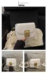Detail view of the white shoulder bag featuring a vintage gold rectangular metal buckle