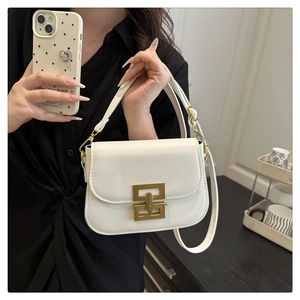 Detail of white PU leather shoulder bag with vintage gold geometric lock and strap