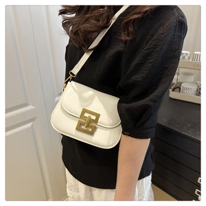 Close-up of a white leather crossbody bag with a vintage gold geometric metal buckle