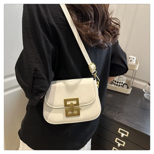 Side view of white crossbody bag showing adjustable shoulder strap and gold geometric clasp