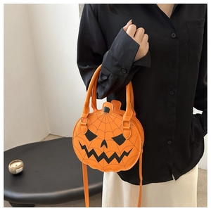 Detail of Jack-o-lantern pumpkin handbag with spider web pattern on orange glossy material