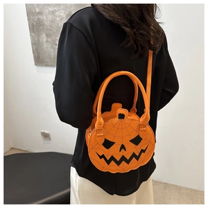 Model showing orange pumpkin crossbody bag with spider web texture for Halloween style