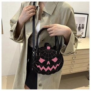 Detail of Halloween pumpkin handbag with pink spider web embroidery and black handle
