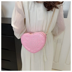 Pink heart-shaped crossbody bag featuring white spider web embroidery and gold chain