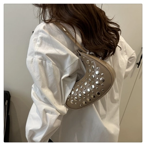 Detail of khaki crescent shoulder bag with silver rivet studs on soft leather material