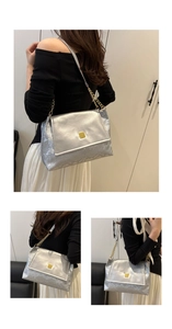 Detail of silver tote bag with snakeskin texture and golden square metal buckle lock