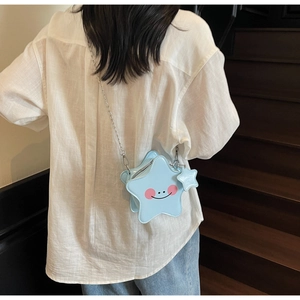Mini star-shaped crossbody bag in light blue with silver chain strap and smiley face