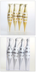 Close-up of gold and silver Christmas teardrop ornaments with white glitter stripes