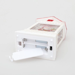 Christmas water lantern house with Santa scene and bottom view of battery compartment