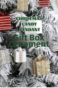 Detailed view of glittering Christmas gift box ornaments hanging on a snowy tree