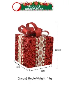 Detail of red glitter Christmas gift box ornament with white lace and gold sequins