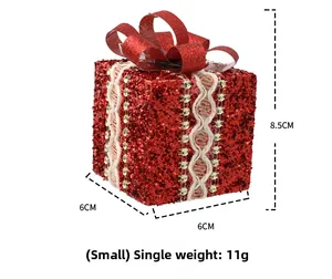Detail view of small red glitter Christmas gift box ornament with lace and gold sequins