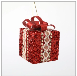Detail of red glitter Christmas gift box ornament with white lace and gold sequins