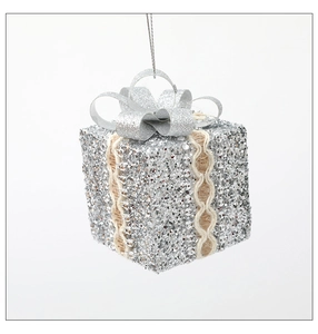 Detail of silver glitter Christmas gift box ornament with burlap ribbon and lace trim