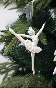 Close-up of iridescent ballerina Christmas ornament with silver hanging silk ribbon