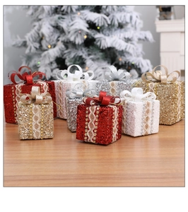 Detailed view of glittery Christmas gift box ornaments with lace, ribbons and rhinestones