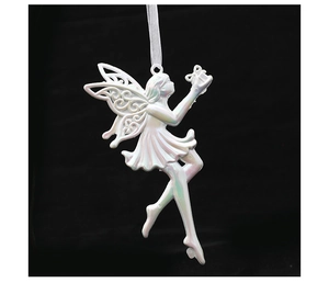 Iridescent white fairy ornament with cutout wings and small gift box on black background