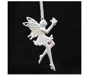 Macro view of pearlescent fairy angel ornament with cutout wings on black backdrop