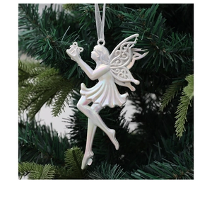 Detailed view of an elegant pearlized fairy ornament with filigree wings on a Christmas tree