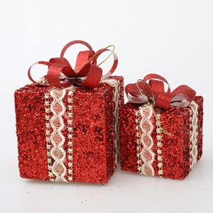 Red glitter Christmas gift boxes with lace ribbons and bows for tree decoration
