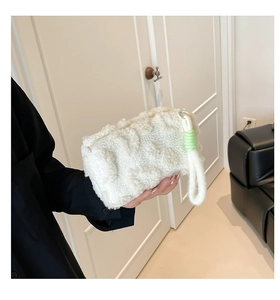Detail of plush off-white teddy fleece makeup bag with lime green wristlet accents