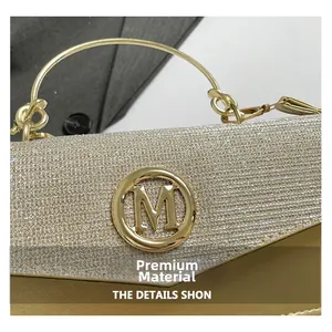 Close-up of gold sequins and metallic M logo detailing on champagne evening clutch