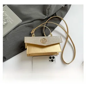 Mini champagne gold square bag with glitter flap and M logo compared with smartphone