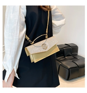 Detail of glitter flap small square crossbody bag with metallic M logo and slim strap