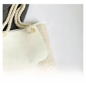 Detail of cream woven tote bag showing premium straw texture and smooth faux leather flap