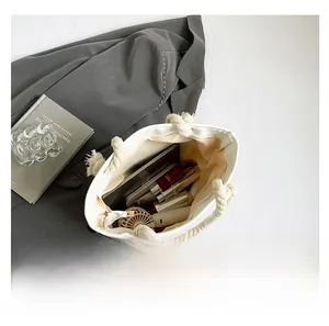 Interior view of off-white woven tote bag showing storage capacity for daily essentials