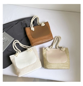 Detailed top view of three woven straw bucket bags with cotton rope handles and PU patches