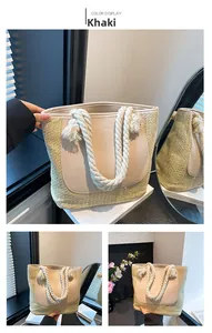 Detail of khaki woven tote bag with smooth leather patch and white cotton rope handles