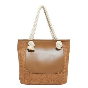 Fashionable woven straw tote bag with brown leather panel and white cotton rope handles