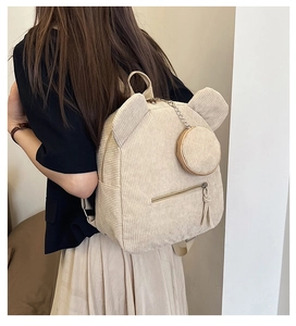 Detail of beige corduroy backpack texture with cute animal ears and a round coin pouch