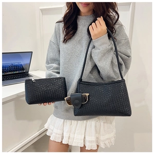 Detail of black woven large shoulder bag set with matching pouch and sunglasses clip