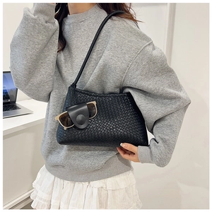 Close-up of black woven shoulder bag with small detachable pouch and textured PU finish