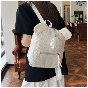 Detailed view of white corduroy backpack with cute bear ears and matching coin pouch