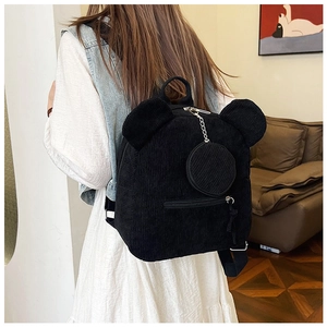 Detail of black corduroy backpack with bear ears and small round hanging pouch