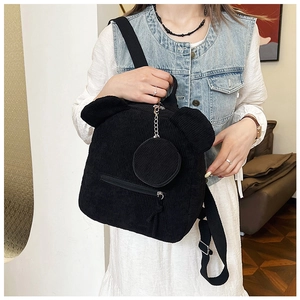 Close-up of black corduroy bucket bag with cute bear ears and detachable coin purse
