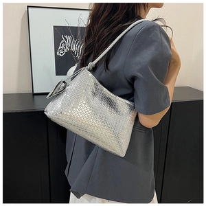 Detailed shot of silver woven hobo bag with metallic finish and braided knot strap detail