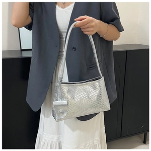 Detailed view of silver woven texture underarm bag with small matching coin purse attachment