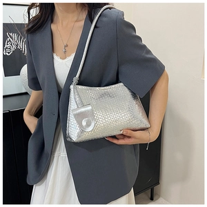 Close-up of silver woven texture PU leather shoulder bag with decorative hangtag
