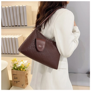 Detail of dark brown woven texture shoulder bag with minimalist rectangular silhouette