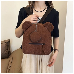 Detail of a brown corduroy bear-shaped backpack with a matching mini round coin purse