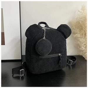 Detail of black corduroy mini backpack with bear ears and circular coin purse pendant