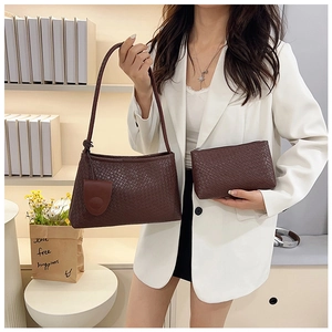 Detailed view of deep brown woven leather baguette bag set with matching clutch